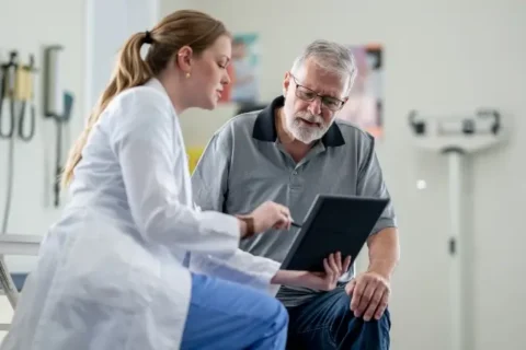 An interventional cardiologist speaks with a patient in Sugar Land, TX