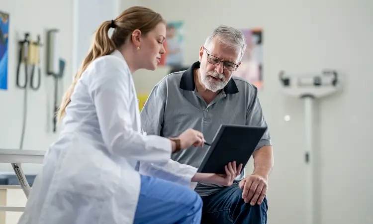 An interventional cardiologist speaks with a patient in Sugar Land, TX