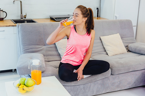 A young girl adheres to the rules of nutrition. Eating fresh fruit and juice.